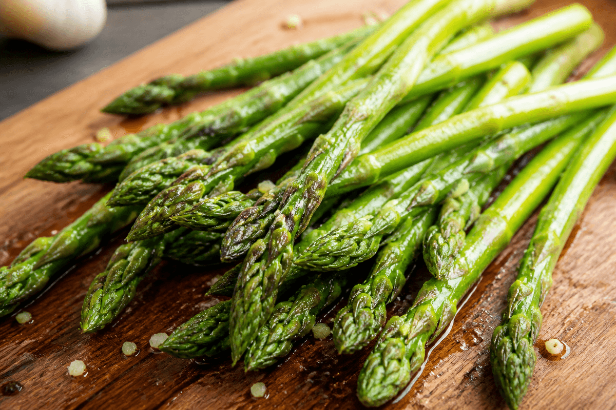 Asparagus spears tossed with oil and seasoning