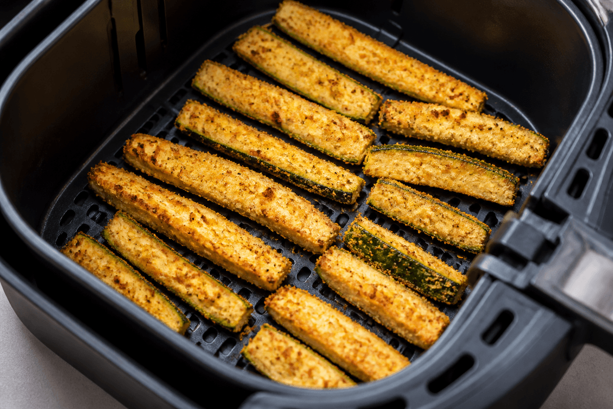 Golden parmesan zucchini fries in the air fryer basket