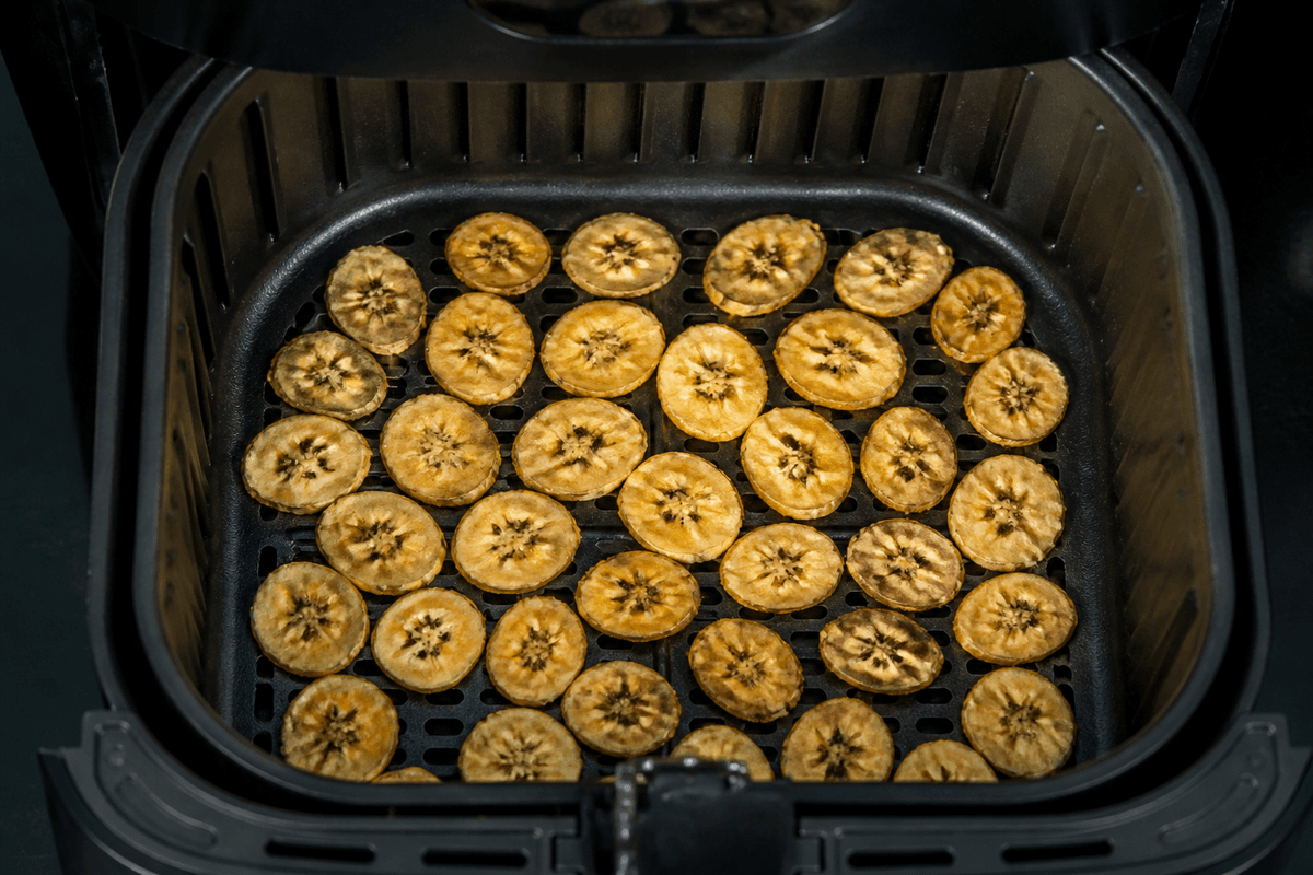 Banana chips dehydrating in the air fryer basket