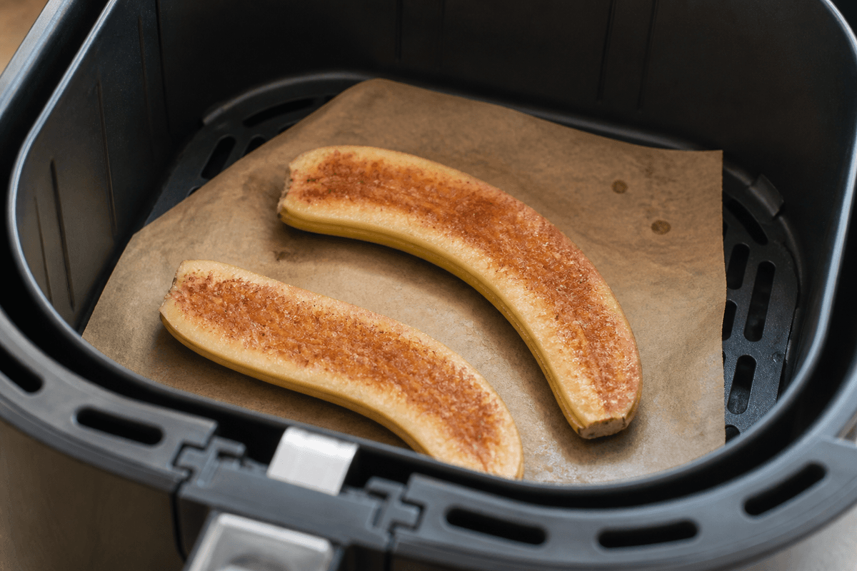 Caramelized banana halves cooking in the air fryer