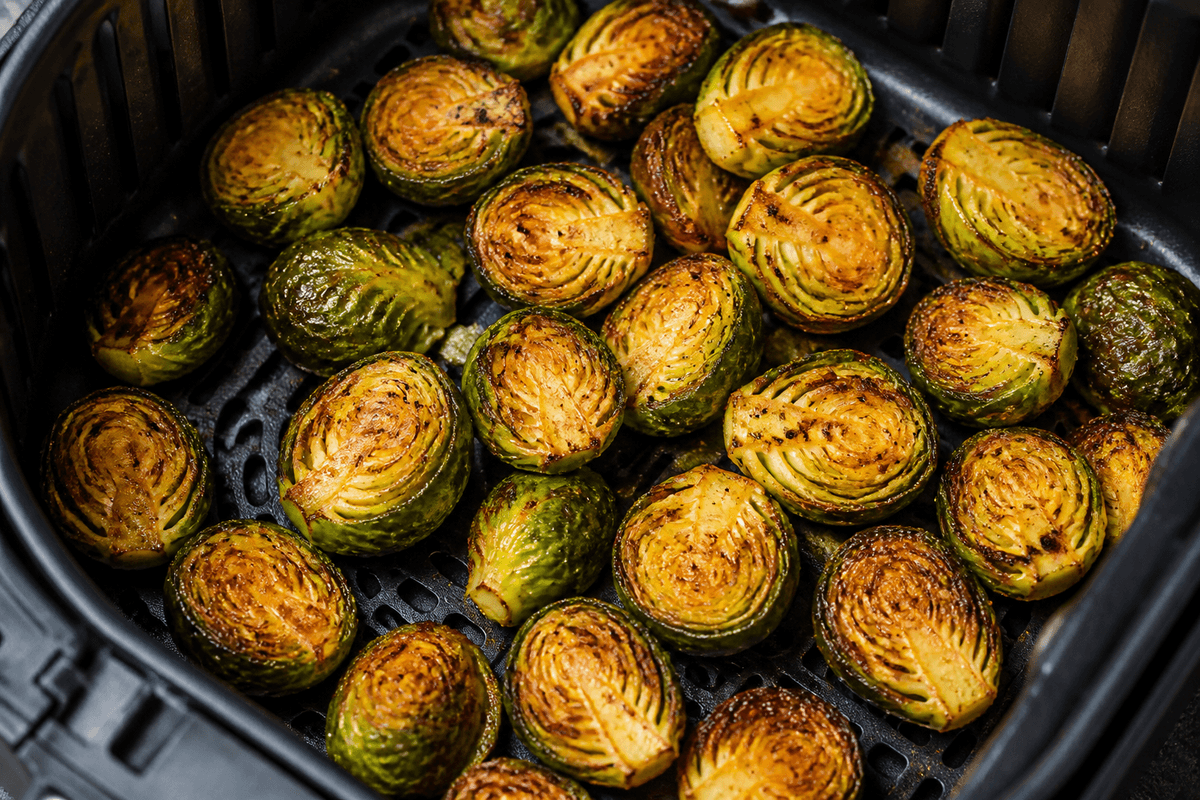 Golden Brussels sprouts in the air fryer basket