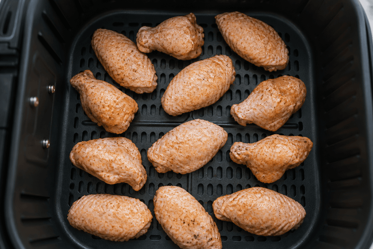 Chicken wings in a single layer in the air fryer basket