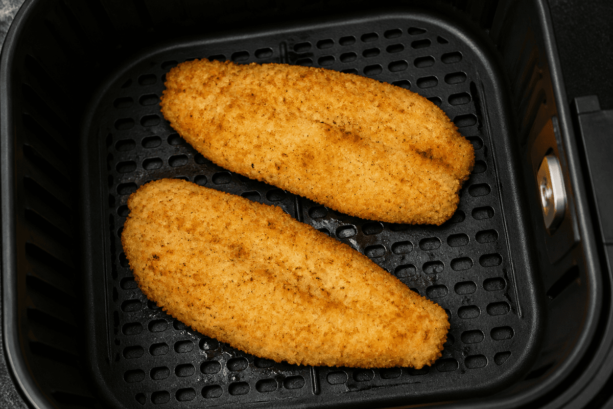 Breaded fish fillets in the air fryer basket
