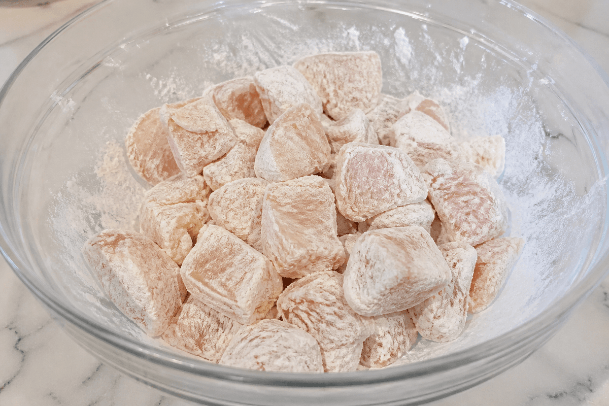 Chicken cubes coated in cornstarch before air frying