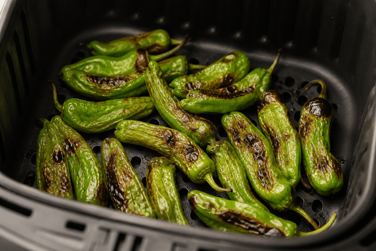 Blistered shishito peppers in the air fryer basket